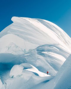 captures the snow-blanketed summit of Chopicalqui in Peru, a majestic peak stand...