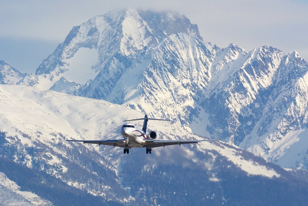 Glide gracefully above the majestic snowy mountains in the agile  aircraft, wher...